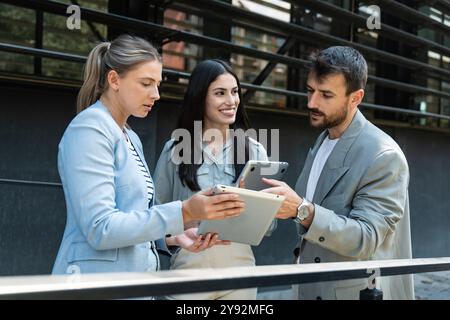Group of young businesspeople stock market and exchange experts, leaders in modern science, finance and economy standing outside of office building. S Stock Photo