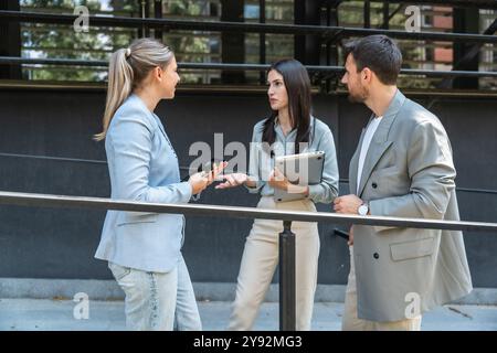 Group of young businesspeople stock market and exchange experts, leaders in modern science, finance and economy standing outside of office building. S Stock Photo