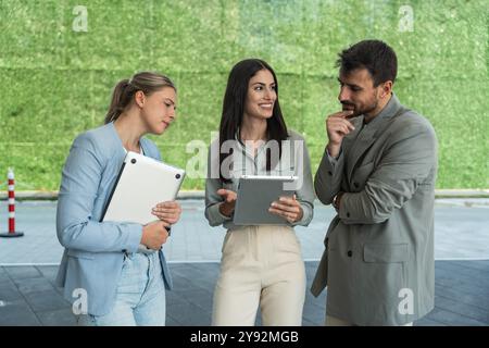 Group of young businesspeople stock market and exchange experts, leaders in modern science, finance and economy standing outside of office building. S Stock Photo