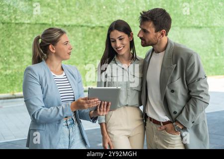 Group of young businesspeople stock market and exchange experts, leaders in modern science, finance and economy standing outside of office building. S Stock Photo