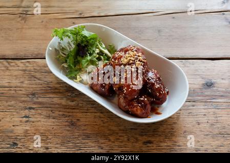 Korean chicken chicken wings, marinated in a spicy bbq sauce starter or side plate Stock Photo