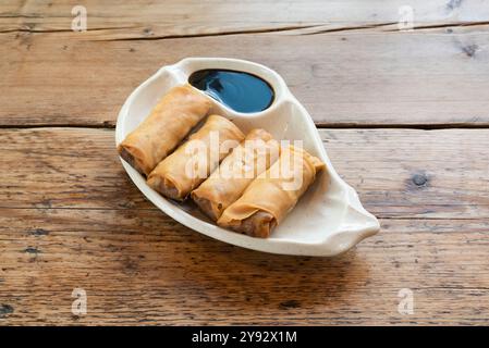 Duck spring rolls served with a soy sauce dip Stock Photo