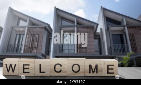 Row of wooden blocks show word 'Welcome' written on it in the table. Welcome greeting for invitation, express hospitality, greet, show acceptance. Des Stock Photo