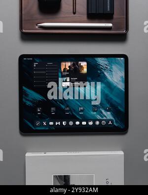 LONDON - OCTOBER 08, 2024: Apple iPad Pro on desk with pencil stylus overhead top view Stock Photo