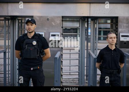 Diverse police officers patrolling and guarding entrance to public subway Stock Photo