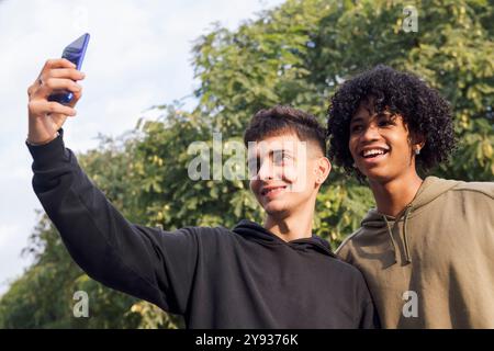two male teens smiling happy taking selfie photo Stock Photo