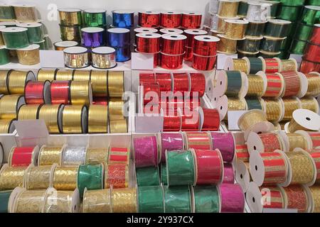 Various colorful ribbons neatly arranged on shelves Stock Photo