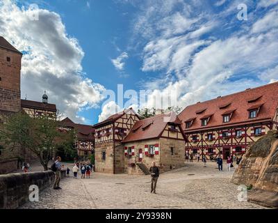 NUREMBERG, GERMANY - JULY 25, 2023: The courtyard of Nuremberg Castle with Heidenturm (Heathens' Tower), Kaiserkapelle (Imperial Chapel), and Tiefer B Stock Photo