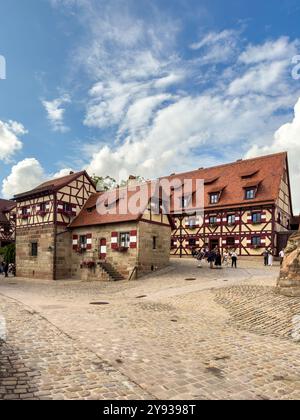 NUREMBERG, GERMANY - JULY 25, 2023: The courtyard of Nuremberg Castle with Heidenturm (Heathens' Tower), Kaiserkapelle (Imperial Chapel), and Tiefer B Stock Photo