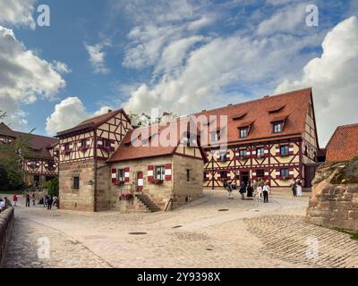 NUREMBERG, GERMANY - JULY 25, 2023: The courtyard of Nuremberg Castle with Heidenturm (Heathens' Tower), Kaiserkapelle (Imperial Chapel), and Tiefer B Stock Photo