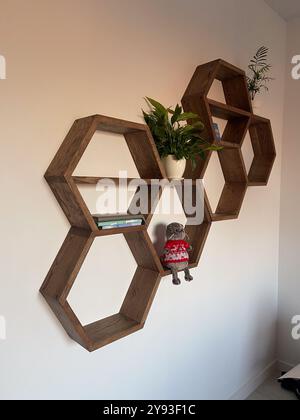 Hexagonal wooden house interior for house walls. Honeycomb shelves for interior home Stock Photo