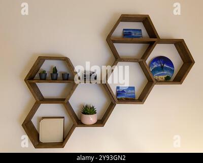 Hexagonal wooden house interior for house walls. Honeycomb shelves for interior home Stock Photo