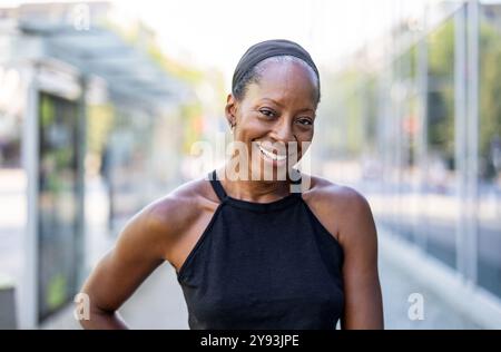 Portrait of smiling woman in the city looking at camera Stock Photo