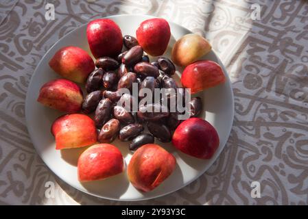 Fruit plate of dates and apple served aboard the Dahabeah, passenger river boat of the Lazuli fleet, sailing on the Nile river, Egypt, North Africa Stock Photo