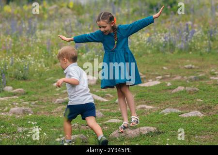 Playful boy running on rocks while holding butterfly fishing net ...