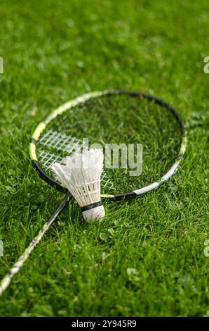Badminton racket and shuttlecock on grass background. High quality photo Stock Photo