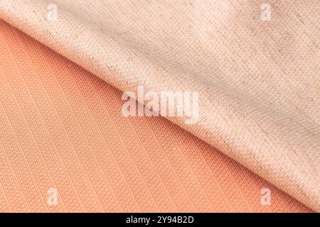 Soft beige and coral fabric textures layered, with a warm and cozy aesthetic Stock Photo