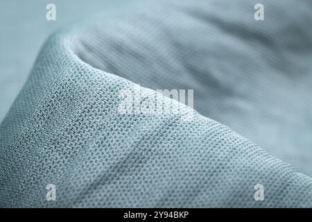 Textured blue fabric close-up showing fine woven details, ideal for textile industry, fashion, and interior decoration backgrounds Stock Photo