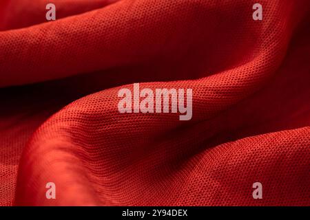 Detailed close-up of red fabric with visible weave and fine texture Stock Photo