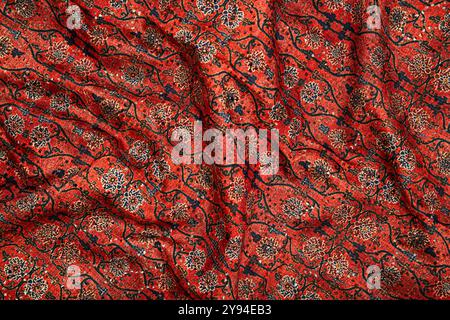 A close-up of traditional red fabric with intricate floral patterns, rich in cultural design and texture Stock Photo