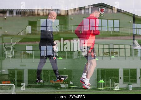 PONTYCLUN, WALES - 07 OCTOBER 2024: Wales’ Physiotherapist Sean Connelly and Wales' Aaron Ramsey during a Wales training Session at the Vale Resort ah Stock Photo