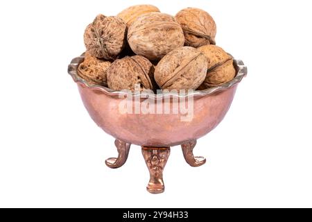 A copper bowl filled with dried walnuts, emphasizing rustic charm and earthy aesthetics Stock Photo