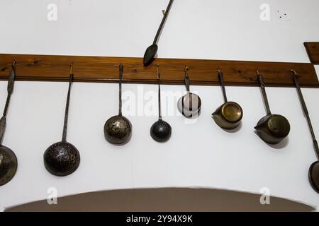 Old pots hanging on a wall at the Pharmacy Museum in Sibiu, Romania Stock Photo