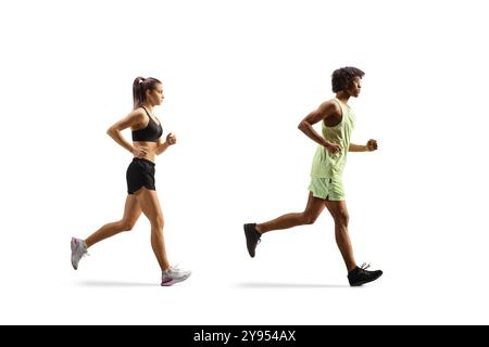 Full length profile shot of a caucasian female and african american male running isolated on white background Stock Photo