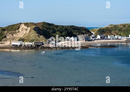 People relax on the beach at Porthdinllaen in Morfa Nefyn on the Llyn Peninsula in North Wales. Stock Photo