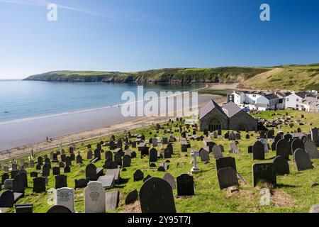 St Hywyn's Church stands on the hillside above Aberdaron village on the coast of the Llyn Peninsula in North Wales. Stock Photo