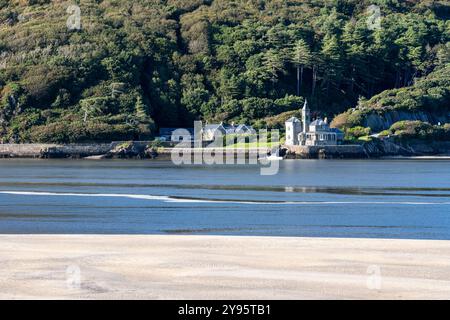 The gothic revival mansion of Coes Faen Hall stands on the shore of the Mawddach Estuary near Barmouth in Wales. Stock Photo