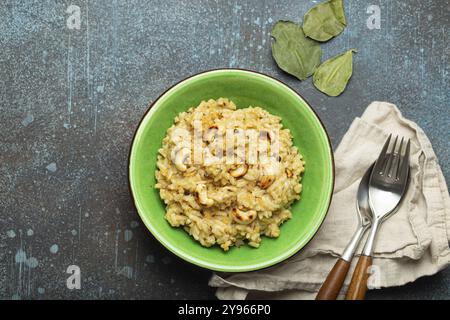 Ven Pongal (Khara Pongal), traditional Indian savoury rice dish made during celebrating Pongal festival, served in bowl top view on concrete rustic ba Stock Photo