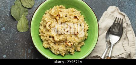 Ven Pongal (Khara Pongal), traditional Indian savoury rice dish made during celebrating Pongal festival, served in bowl top view on concrete rustic ba Stock Photo