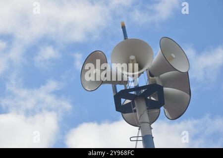 six white metal loudspeakers against the the sky Stock Photo
