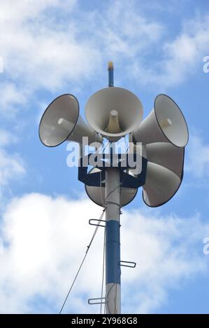 six white metal loudspeakers against the the sky Stock Photo