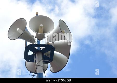 six white metal loudspeakers against the the sky Stock Photo