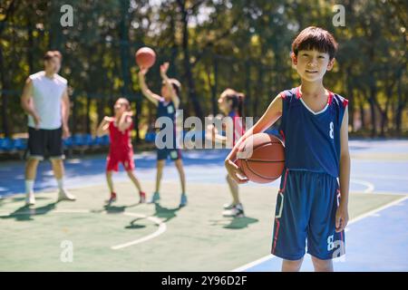 Coach and Kids in Basketball Training Class Stock Photo