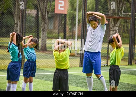 Coach and Kids in Football Training Class Stock Photo