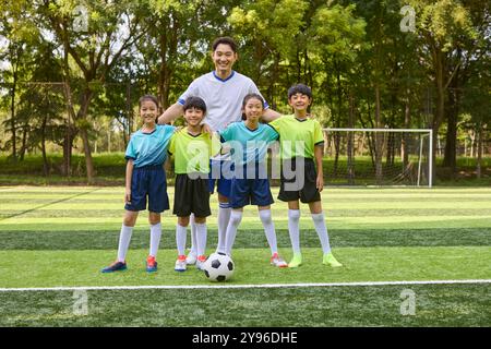 Coach and Kids in Football Training Class Stock Photo