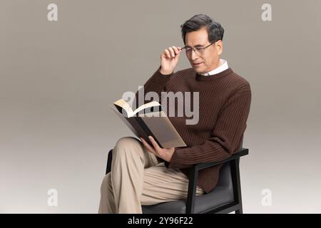 Happy senior man reading a book Stock Photo