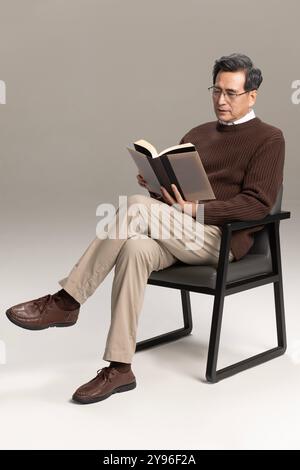 Happy senior man reading a book Stock Photo