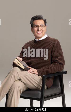 Happy senior man reading a book Stock Photo