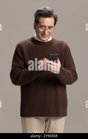 Happy senior man using smart phone Stock Photo