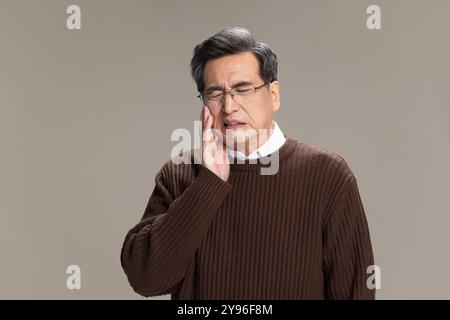 Senior man suffering from toothache Stock Photo