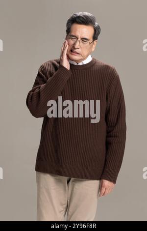 Senior man suffering from toothache Stock Photo