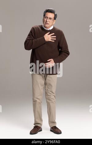 Senior man having a heart attack Stock Photo