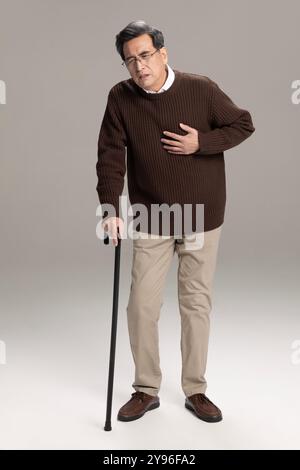 Senior man having a heart attack Stock Photo