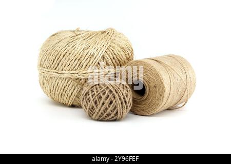 Close-up image of three natural twine ropes of different sizes on a white background, highlighting craft and eco-friendly materials Stock Photo