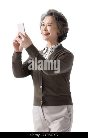 Happy senior woman using smart phone Stock Photo
