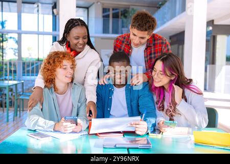 Happy diverse group of students studying in the library Stock Photo